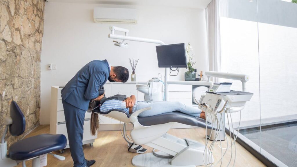 A dentist working on patient's teeth in a dentist's office