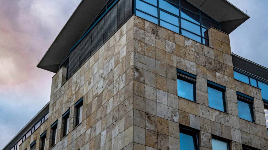 A modern building's facade made out of natural stone