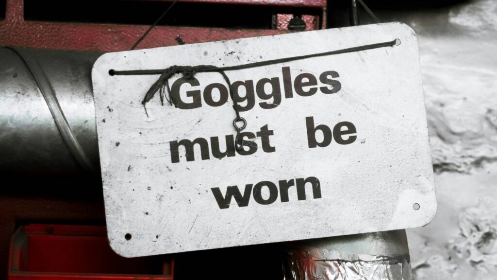 A warning sign saying "goggles must be worn" 