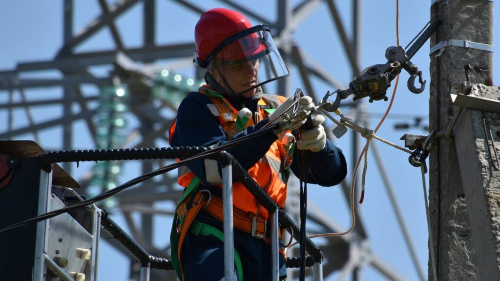 A professional electrician checking a cable 