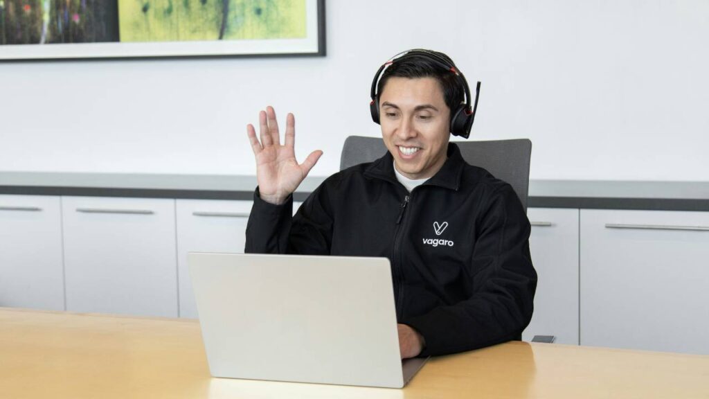 A photo of a company worker having an online conversation with a customer