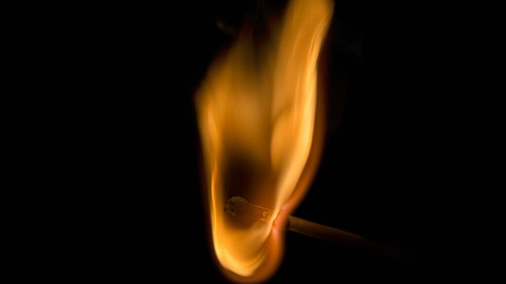 A close-up photo of a lit matchstick